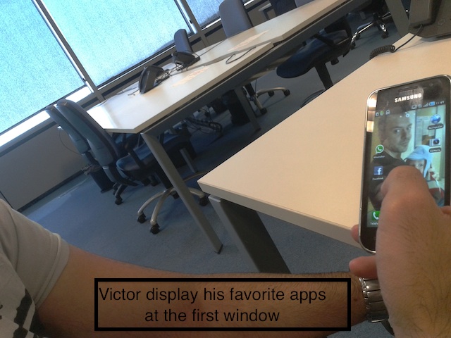 User 2 looking at his mobile device: Victor display his favorite apps at the first window